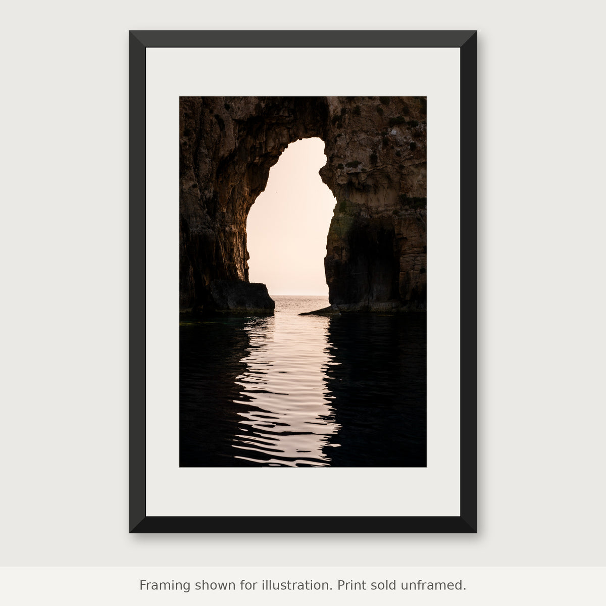 Navarino Sea Arch photograph in a black frame with a white mat. Print sold unframed.