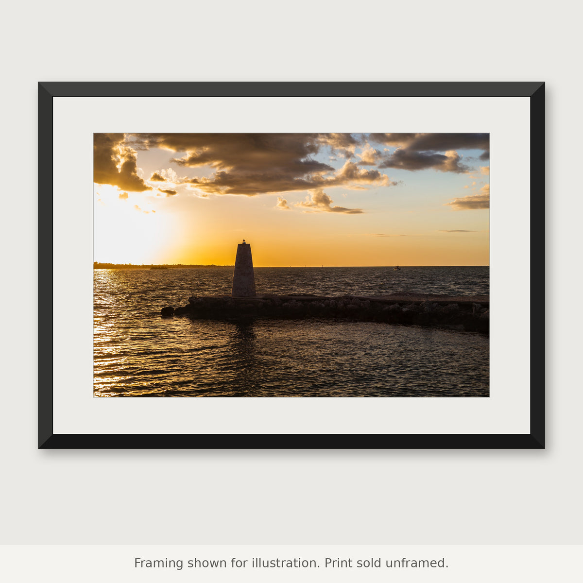 Stone harbor beacon beside the water in warm golden-hour light in the Florida Keys. Print sold unframed.

