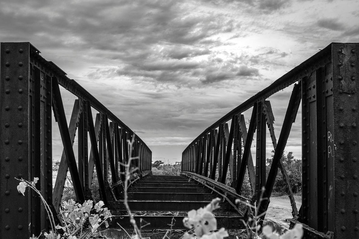 Black-and-white photograph of an abandoned steel bridge in Cabo Rojo, Puerto Rico.