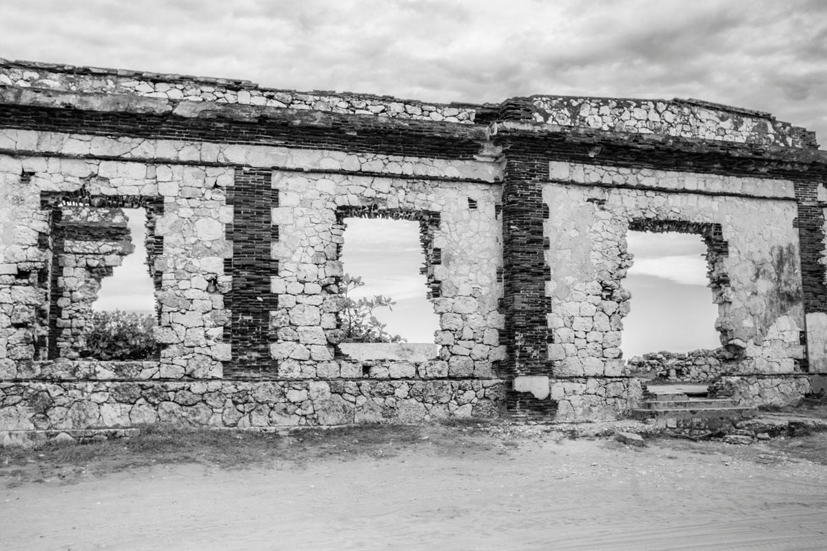 Black-and-white photograph of weathered windows at the Punta Borinquen Lighthouse ruins in Aguadilla, Puerto Rico.